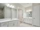 Double vanity bathroom with white cabinets and grey tile floors at 6257 Hidden Branch Dr, Apollo Beach, FL 33572