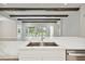 Modern kitchen island with quartz countertop and stainless steel sink at 6257 Hidden Branch Dr, Apollo Beach, FL 33572