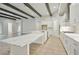 Spacious kitchen with white cabinets, large island, and wood beams at 6257 Hidden Branch Dr, Apollo Beach, FL 33572