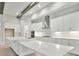 Modern white kitchen with large island and stainless steel appliances at 6257 Hidden Branch Dr, Apollo Beach, FL 33572