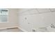 Laundry room with utility sink, shelving and vinyl flooring at 6257 Hidden Branch Dr, Apollo Beach, FL 33572