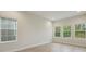 Bright office space featuring wood-look floors and multiple windows at 6257 Hidden Branch Dr, Apollo Beach, FL 33572