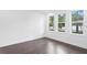Bright bedroom with hardwood floors and three windows at 2442 W Mississippi Ave # 6, Tampa, FL 33629