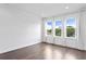 Bright bedroom with hardwood floors and three windows at 2442 W Mississippi Ave # 6, Tampa, FL 33629
