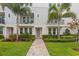 Townhome entry with a paved walkway and landscaping at 2442 W Mississippi Ave # 6, Tampa, FL 33629