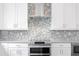 Modern kitchen with stainless steel appliances and white cabinetry at 2442 W Mississippi Ave # 6, Tampa, FL 33629