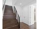 Modern staircase with dark hardwood and metal railing at 2442 W Mississippi Ave # 6, Tampa, FL 33629