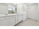 Modern bathroom with double vanity and gray tile floors at 10536 Hidden Banks Gln, Parrish, FL 34219