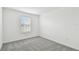 Well-lit bedroom with gray carpet and window at 10536 Hidden Banks Gln, Parrish, FL 34219