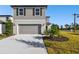 Two-story house with gray siding, two-car garage, and landscaping at 10536 Hidden Banks Gln, Parrish, FL 34219