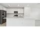 Modern kitchen with white cabinets, stainless steel appliances, and island at 10536 Hidden Banks Gln, Parrish, FL 34219