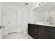 Bathroom with dark vanity, double sinks, and a shower at 10627 Hidden Banks Gln, Parrish, FL 34219