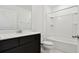 Bathroom with dark vanity, white bathtub, and a large mirror at 10627 Hidden Banks Gln, Parrish, FL 34219