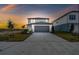 Two-story home with gray garage door and landscaping at 10627 Hidden Banks Gln, Parrish, FL 34219