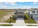 Two-story house with gray garage door and landscaping at 10627 Hidden Banks Gln, Parrish, FL 34219