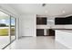 Kitchen with dark cabinets, stainless steel appliances, and sliding glass doors to backyard at 10627 Hidden Banks Gln, Parrish, FL 34219