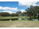 Picturesque golf course view with mature trees and a serene pond at 6132 Silver Oaks Dr, Zephyrhills, FL 33542