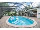 Relaxing kidney-shaped pool with screened enclosure at 6132 Silver Oaks Dr, Zephyrhills, FL 33542