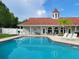 Sparkling community pool with adjacent clubhouse at 13417 Whitehaven Ct, Spring Hill, FL 34609