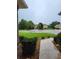 Wet front yard view with walkway and neighborhood view at 13417 Whitehaven Ct, Spring Hill, FL 34609