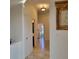 Long hallway with tile flooring and access to laundry and bathroom at 13417 Whitehaven Ct, Spring Hill, FL 34609