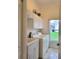 Laundry room with white cabinets and window at 13417 Whitehaven Ct, Spring Hill, FL 34609