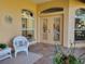 Relaxing patio with tiled floor, wicker chair, and view of kitchen at 13417 Whitehaven Ct, Spring Hill, FL 34609