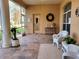 Cozy screened porch with tiled floor, wicker chairs, and a tranquil view at 13417 Whitehaven Ct, Spring Hill, FL 34609