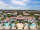 Aerial view of the community featuring swimming pools, lounge areas, and beautiful landscaping at 6030 Printery St # 105, Tampa, FL 33616