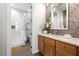 Well-lit bathroom with walk-in shower, stylish vanity, mosaic tile accents, and modern fixtures at 6030 Printery St # 105, Tampa, FL 33616