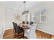 This dining room has wood floors, three windows, and a modern light fixture over the dining table at 6030 Printery St # 105, Tampa, FL 33616