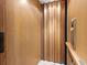 The elevator has a modern, wood-paneled design with a door and control panel visible at 6030 Printery St # 105, Tampa, FL 33616