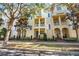 Charming yellow townhouses with private balconies and manicured landscaping offer inviting curb appeal at 6030 Printery St # 105, Tampa, FL 33616