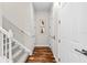 Hallway features hardwood floors and white trim, leading to carpeted stairs and multiple doors at 6030 Printery St # 105, Tampa, FL 33616