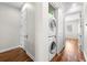 Bright laundry room featuring a stackable washer and dryer and beautiful hardwood floors at 6030 Printery St # 105, Tampa, FL 33616