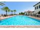 Beautiful pool and deck overlooking the marina with lounge chairs and palm trees at 6030 Printery St # 105, Tampa, FL 33616