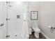 Modern bathroom with walk-in shower, white tile, glass door, and contemporary toilet at 6030 Printery St # 105, Tampa, FL 33616