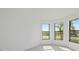 Bright bedroom with multiple windows and wood-look floors at 1877 Pepper Grass Dr, North Port, FL 34289