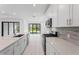 Modern kitchen with white cabinets, quartz countertops, and stainless steel appliances at 1877 Pepper Grass Dr, North Port, FL 34289