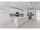 Modern kitchen with white cabinets, quartz countertops, and stainless steel appliances at 1877 Pepper Grass Dr, North Port, FL 34289