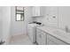 Well-appointed laundry room with washer, dryer, and countertop at 1877 Pepper Grass Dr, North Port, FL 34289