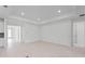 Spacious living area with light flooring and access to other rooms at 1877 Pepper Grass Dr, North Port, FL 34289