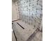 Shower with marble-look wall tiles and a tiled floor at 4021 W Santiago St, Tampa, FL 33629