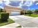 A well-maintained home featuring a spacious driveway, manicured lawn, and attached two-car garage at 7827 Starfire Way, New Port Richey, FL 34654