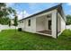Exterior view showcasing the covered patio and backyard with a well-manicured lawn at 2724 W Dewey St, Tampa, FL 33607