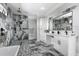 The opulent bathroom is upgraded with black hardware, floor-to-ceiling tile, and an updated vanity at 2724 W Dewey St, Tampa, FL 33607