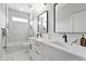 Modern bathroom with double vanity, sleek fixtures, and a combined shower and tub at 2724 W Dewey St, Tampa, FL 33607