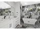 Modern bathroom with soaking tub, elegant fixtures, and a marble-patterned backsplash and floor at 2724 W Dewey St, Tampa, FL 33607