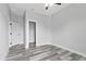 Spacious bedroom with gray wood floors, walk-in closet, and a ceiling fan at 2724 W Dewey St, Tampa, FL 33607