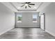 Bright bedroom featuring a ceiling fan, modern light fixtures, and a large window at 2724 W Dewey St, Tampa, FL 33607